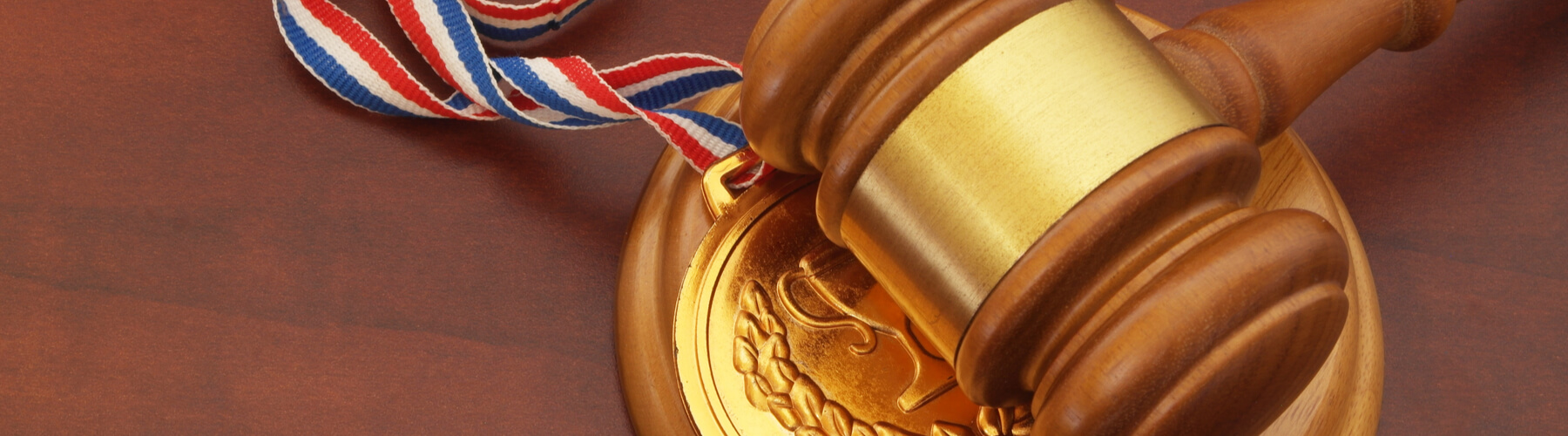Medal and wooden judge's gavel on top of award