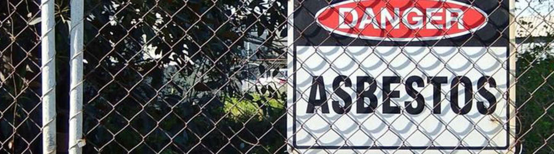 danger asbestos sign on a fence