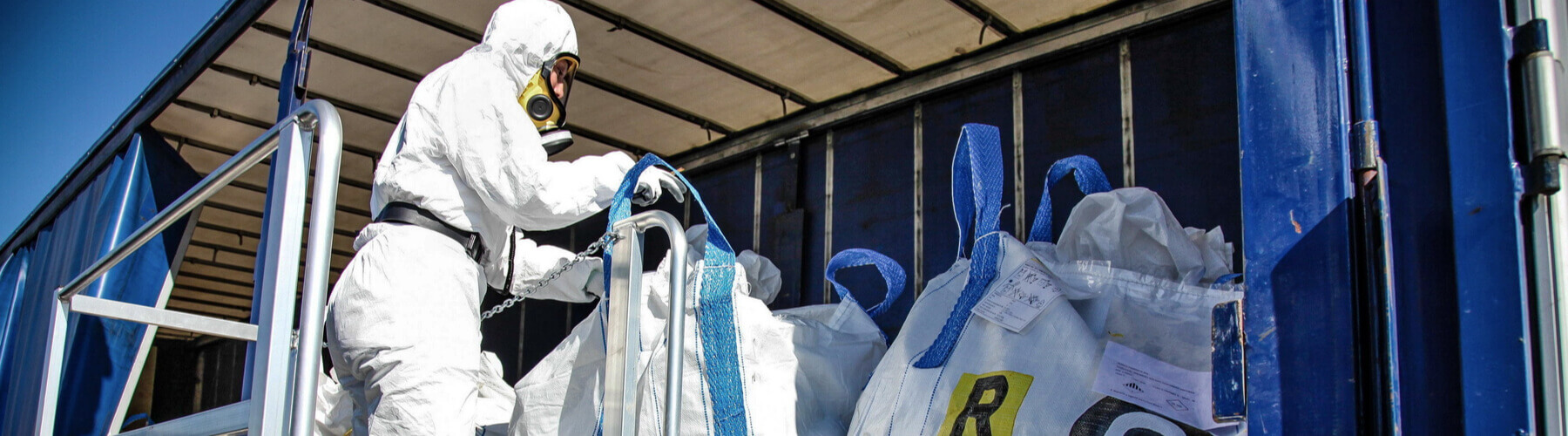 man in hazard suit, removal of asbestos from home or building