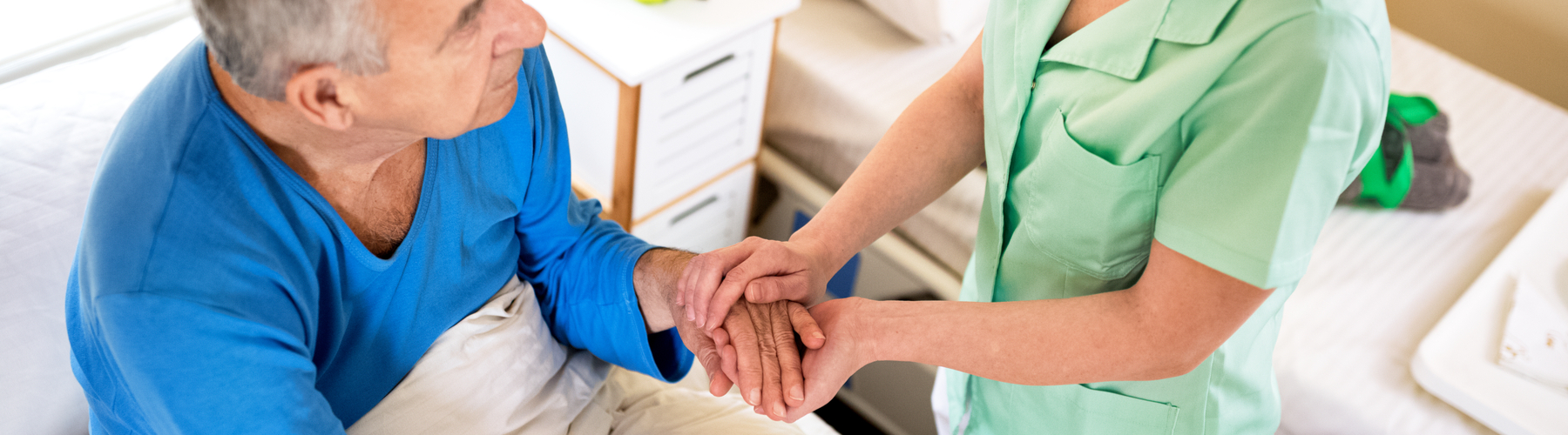 Woman caring for elderly man