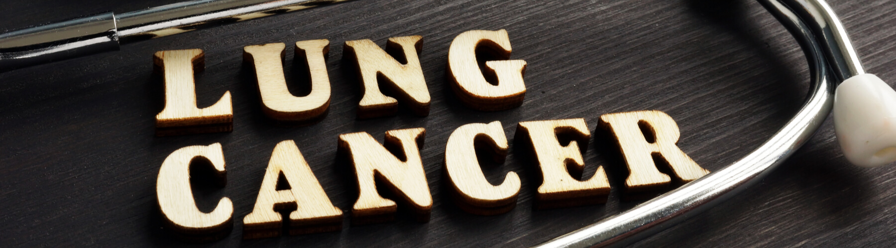 Lung cancer spelt out with wooden letters with stethoscope