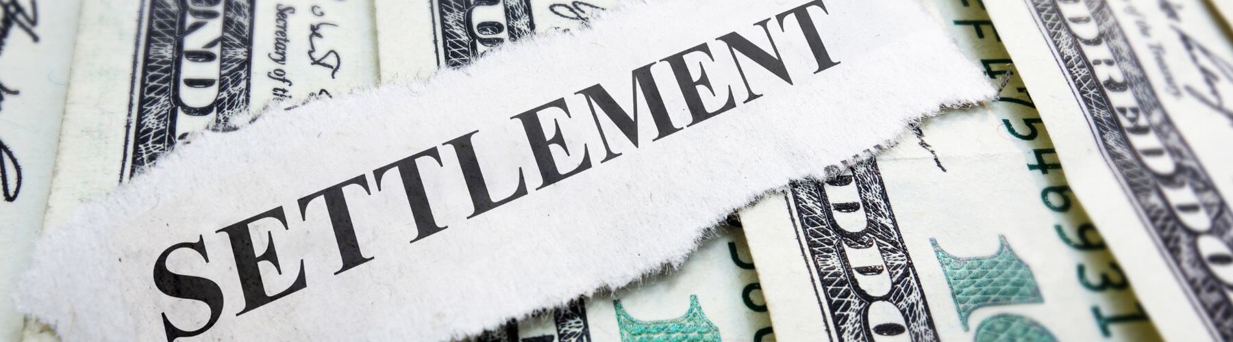 cutout of word Settlement on top of money