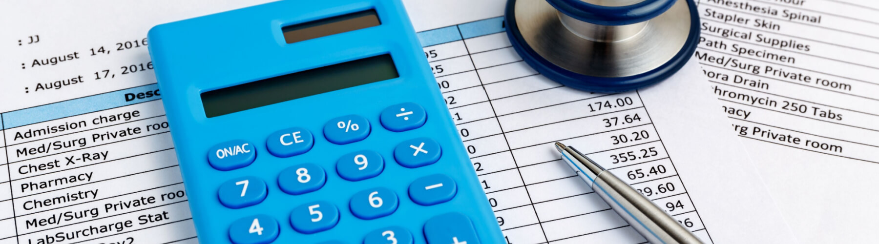 calculator and stethoscope on top of medical bill