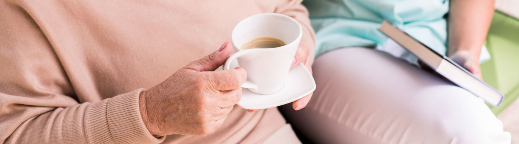 Nursing home patient, holding coffee