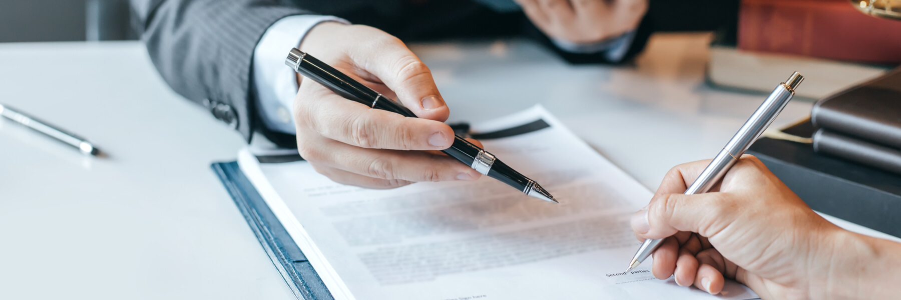 Attorney reviewing legal document with client for signature