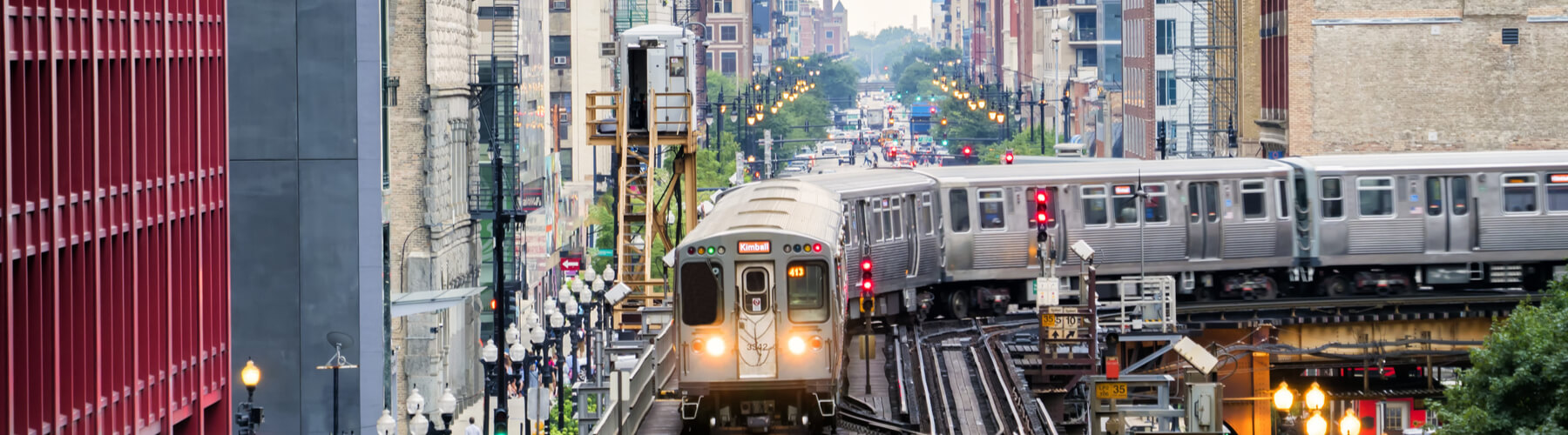 Train on elevated tracks within buildings at the Loop, Glass and Steel bridge between buildings - Chicago City Center - Chicago, Illinois, USA  W