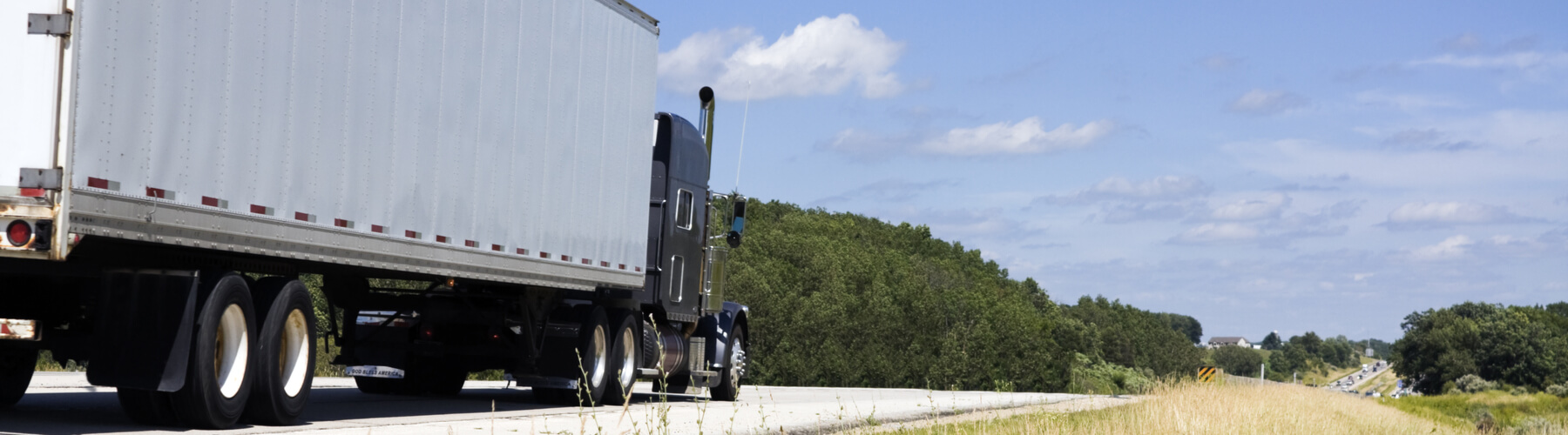 Semi truck on the road during summer time