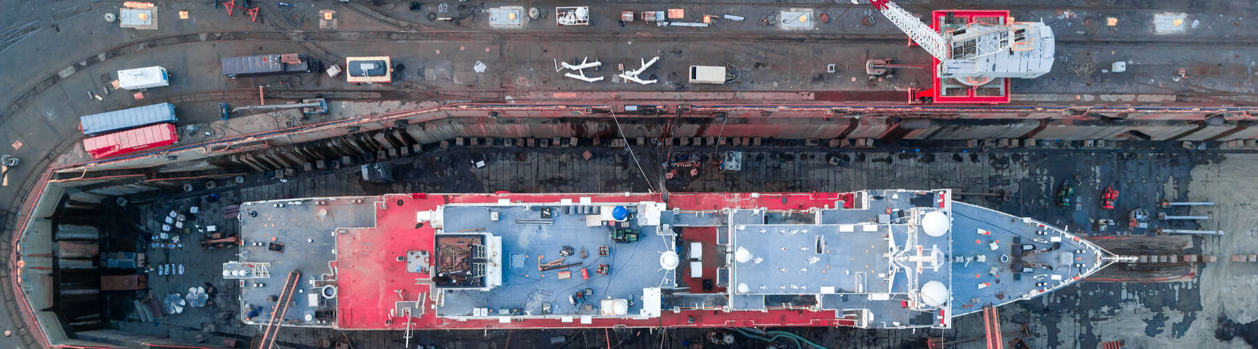 Aerial view of a shipyard repairing a large ship