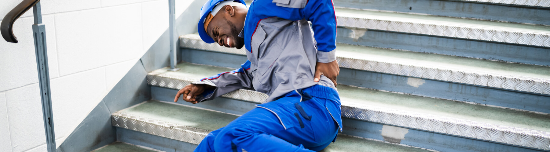 Worker Man Lying On Staircase After Slip And Fall Accident