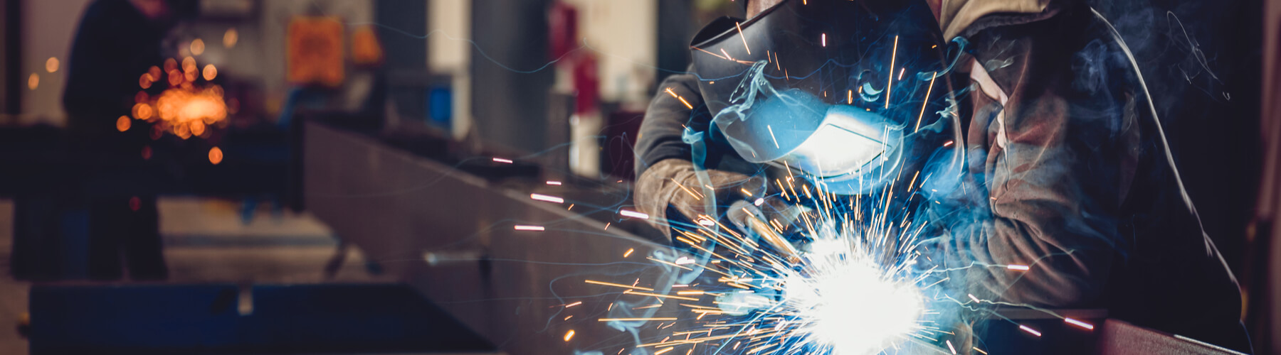 Steelworker or Industrial Welder With Torch and Protective Helmet