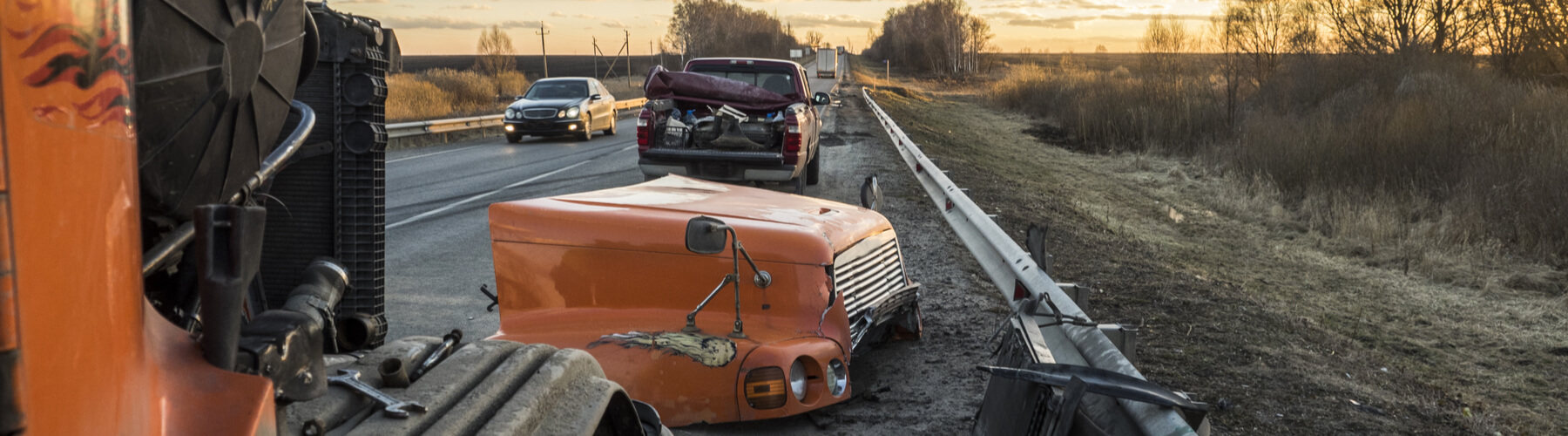 Trucking accident, semi truck crash, rear ended small pickup truck, closeup image of the damage done to the front of a semi truck and rear of a pickup truck due to an accident