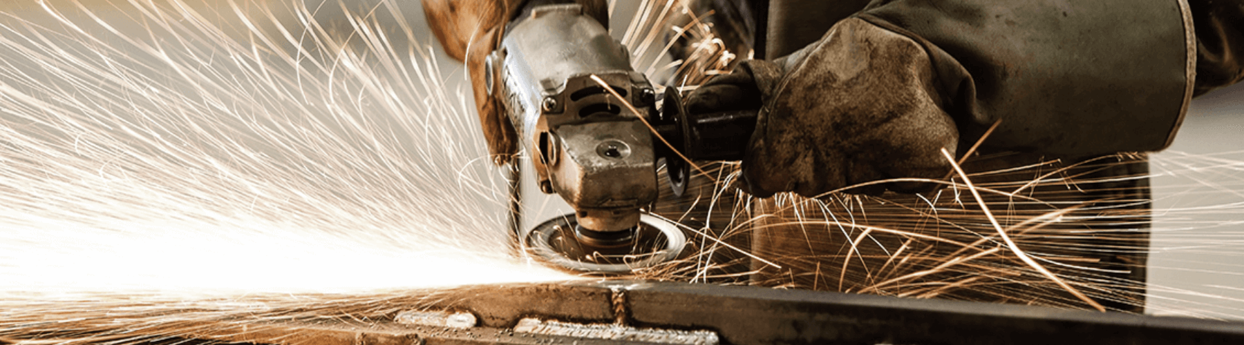 Hard working man welding metal with gloves on