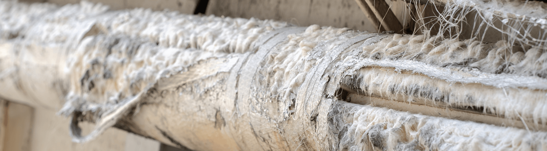 Close up of a pipe, with tape adhesive wrapped around it, containing asbestos