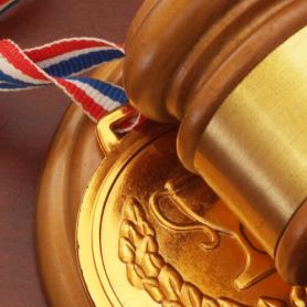 Medal and wooden judge's gavel on top of award