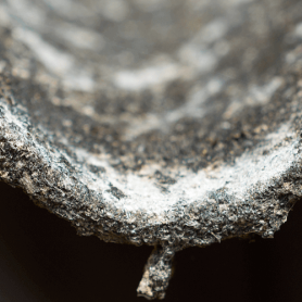 A closer look at a cement sheet with asbestos dust on it.