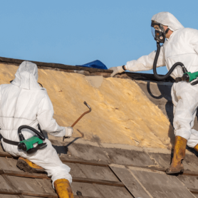 Professionals in protective suits removing asbestos