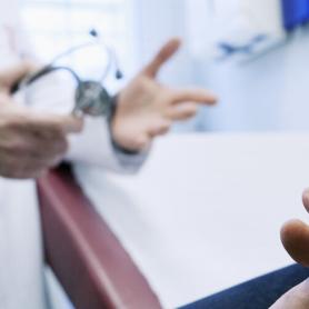 Mesothelioma patient talking to doctor, closeup of patient hand. Man In Consultation, Dialogue with doctor