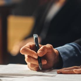attorney in courtroom making notes at the table