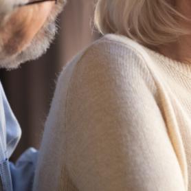 Close up focus on elderly wife hold hand on chest having chest pain