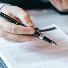 Attorney reviewing legal document with client for signature