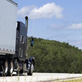 Semi truck on the road during summer time