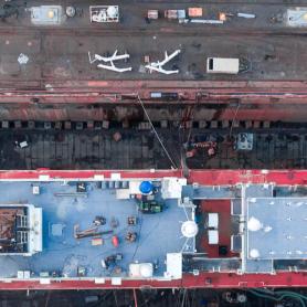 Aerial view of a shipyard repairing a large ship