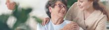 helpful caregiver comforting smiling senior woman, comforting senior patient
