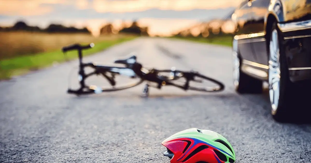 Bicycle down with helmet after accident with car