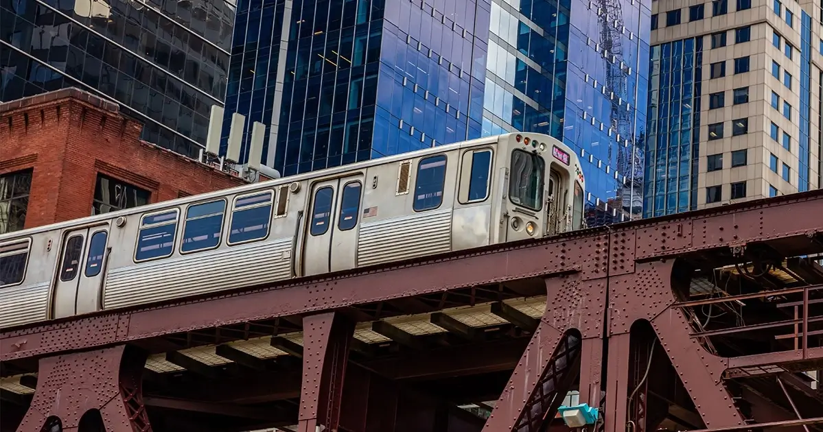 Elevated train moving through a city, representing urban transit accidents