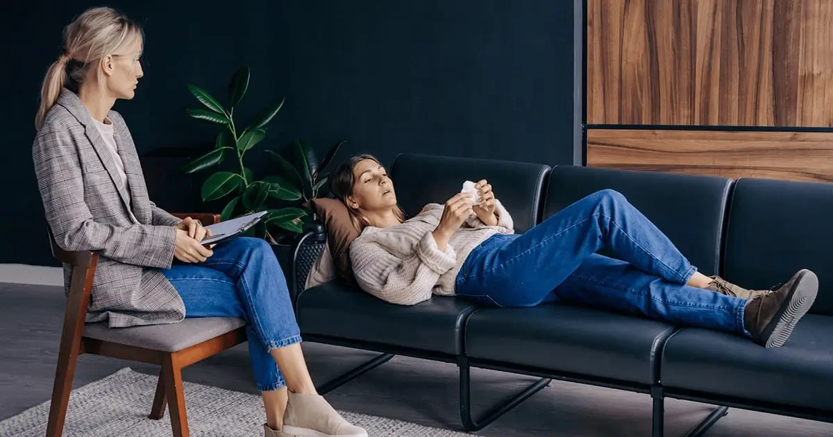 Counselor comforting a woman during a therapy session