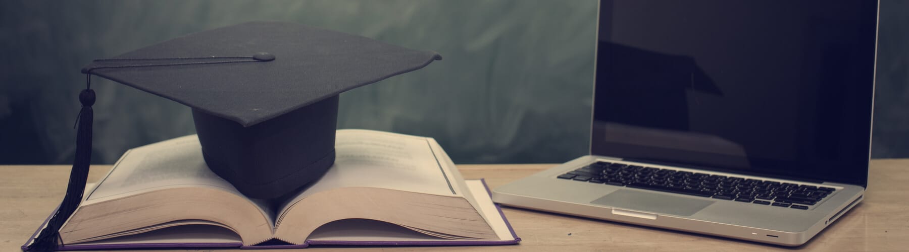 A computer, a book and a cap