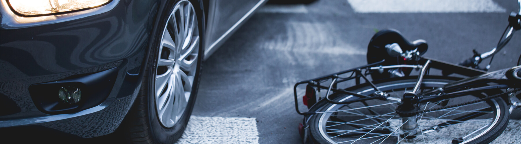 car next to bike on ground