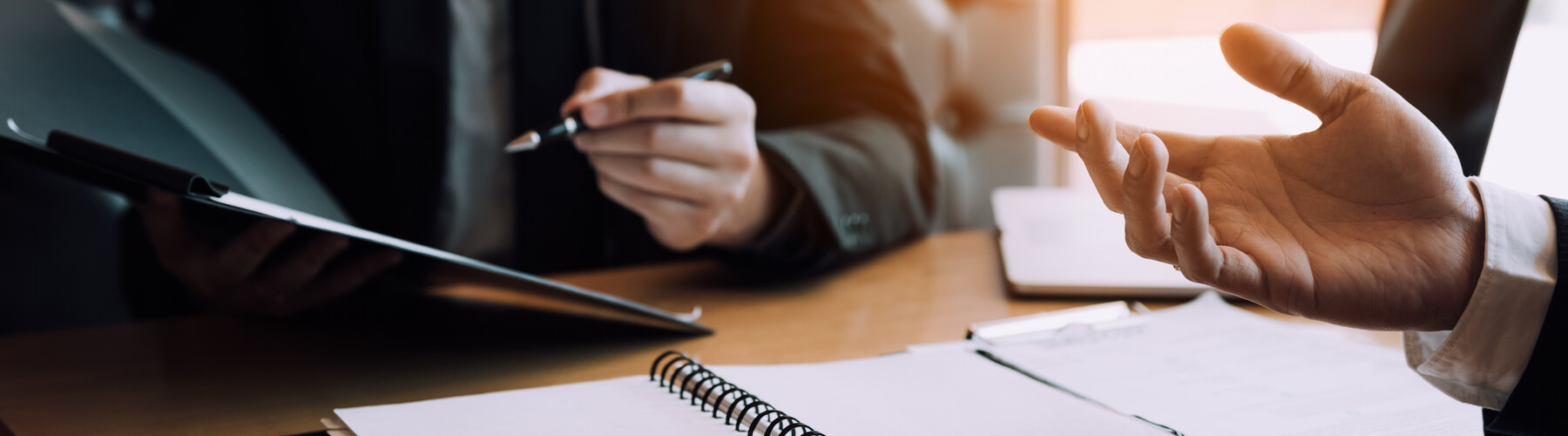 Two people signing documents