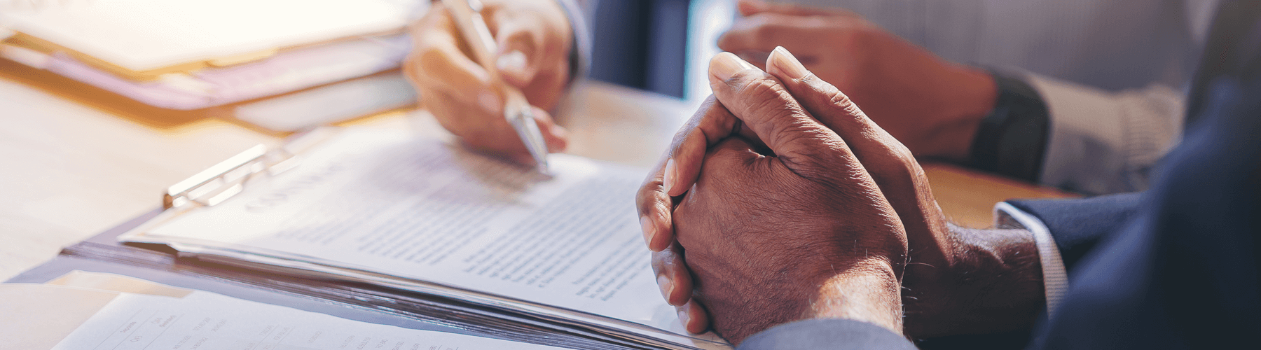 Two people signing documents